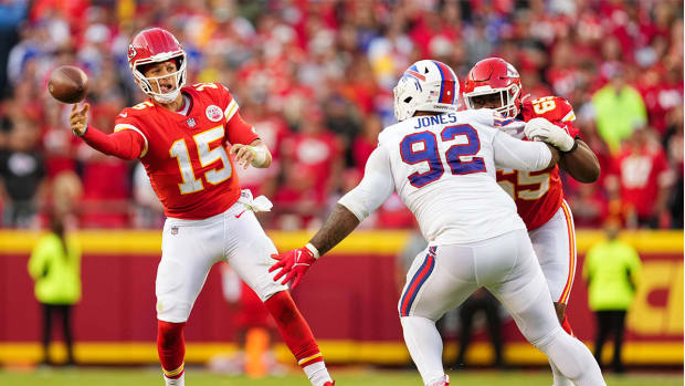 Oct 16, 2022; Kansas City, Missouri, USA; Kansas City Chiefs quarterback Patrick Mahomes (15) throws a pass as Buffalo Bills defensive tackle DaQuan Jones (92) defends during the second half at GEHA Field at Arrowhead Stadium.